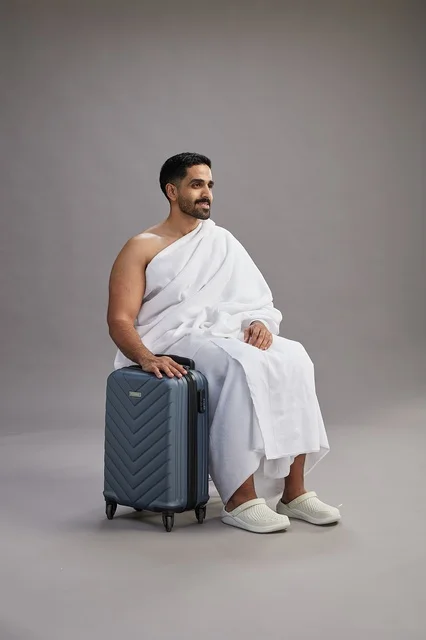 Saudi Pilgrim in Ihram with Suitcase in Studio