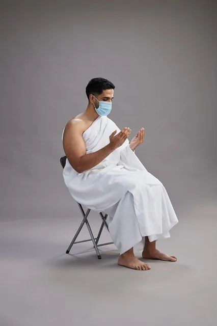 Saudi Man in Ihram Wearing Mask Praying in Studio