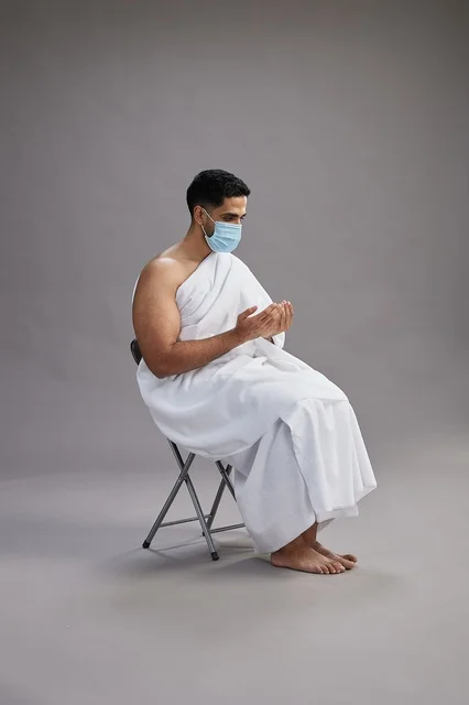 Saudi Man in Ihram Wearing Mask Praying in Studio