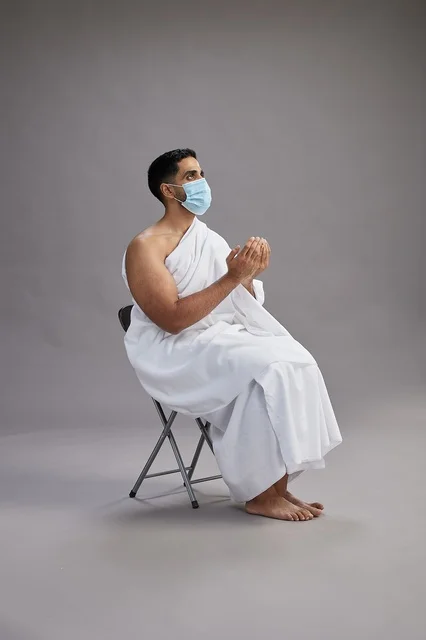 Saudi Man in Ihram Praying with Face Mask in Studio