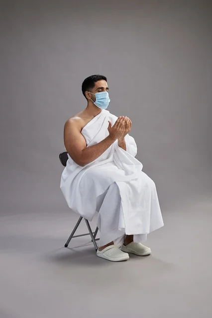 Saudi Man in Ihram Praying with Face Mask