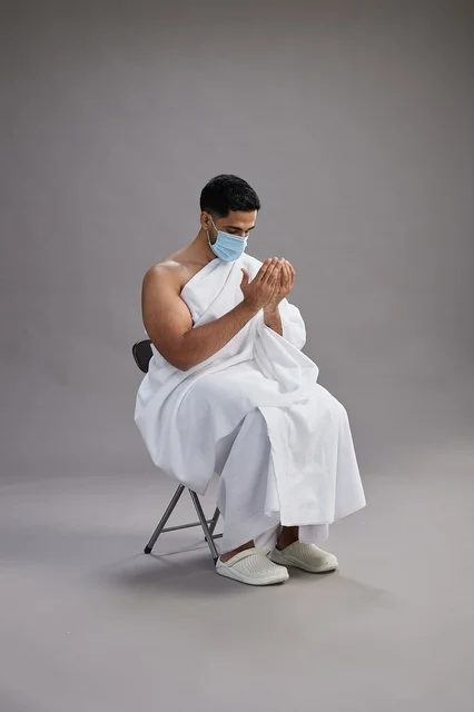 Saudi Man in Ihram Wearing Mask Performing Supplication