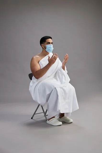 Saudi Man in Ihram Wearing Mask Making Supplication