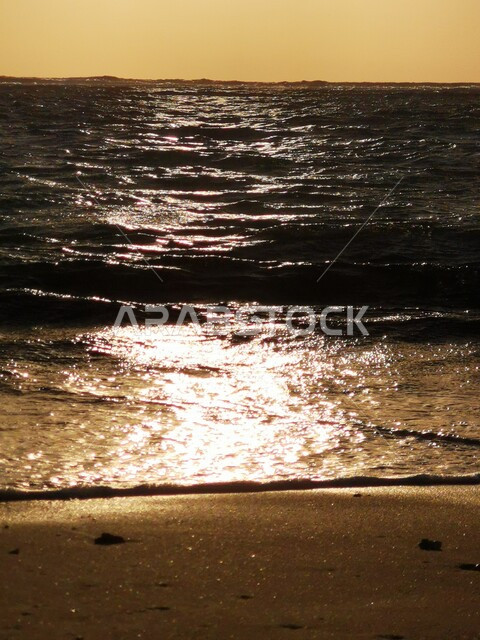 A picture of a sunset on the seashore in Saudi Arabia, Aesthetic view of a sunset on the seashore, landscapes in Saudi Arabia