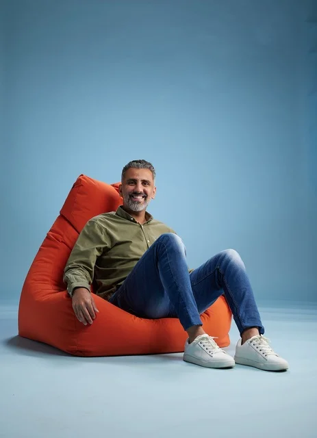 Arab Man on Orange Beanbag Studio Portrait