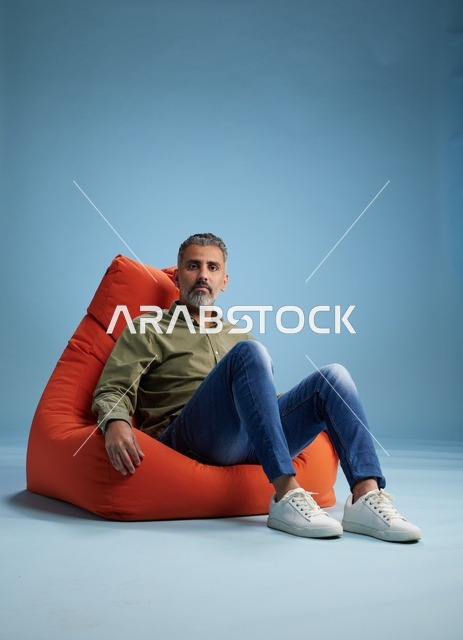 رجل من الشرق الأوسط يجلس على كرسي مريح