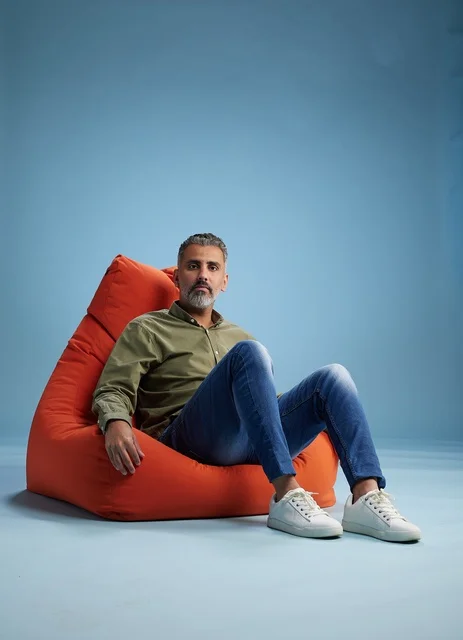 Middle Eastern Man Sitting on Red Bean Bag