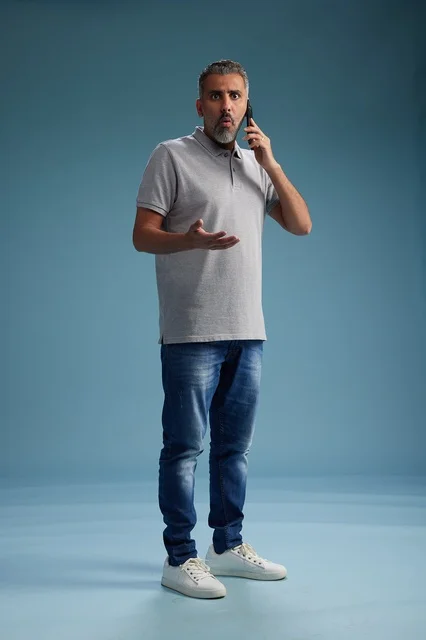 Saudi Man Talking on Smartphone with Surprised Face