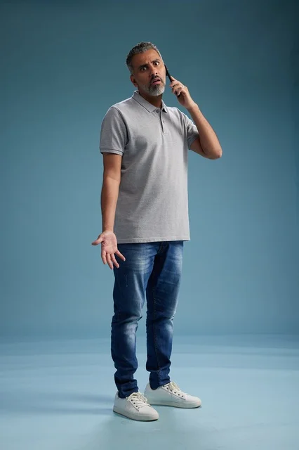 Saudi Man Talking on Smartphone with Confused Expression