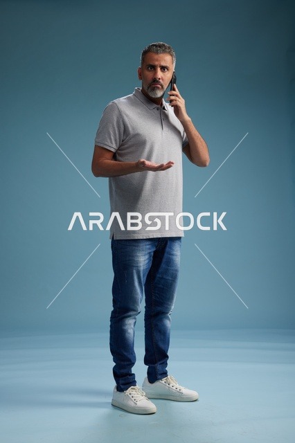Saudi Man Talking on Mobile Phone with Confused Look