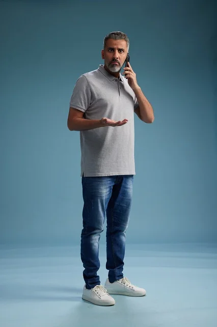 Saudi Man Talking on Mobile Phone with Confused Look