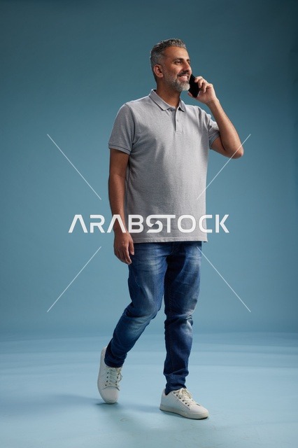 Saudi Man in Casual Clothes Talking on Smartphone