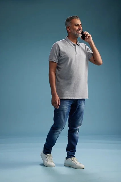 Saudi Man in Casual Clothing Talking on Smartphone