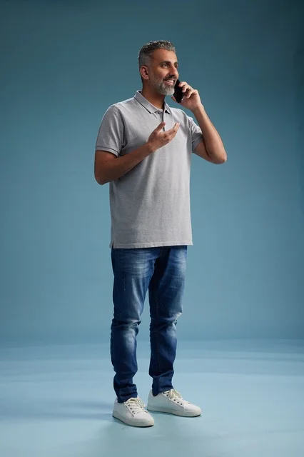 Saudi Man in Casual Clothing Talking on Smartphone