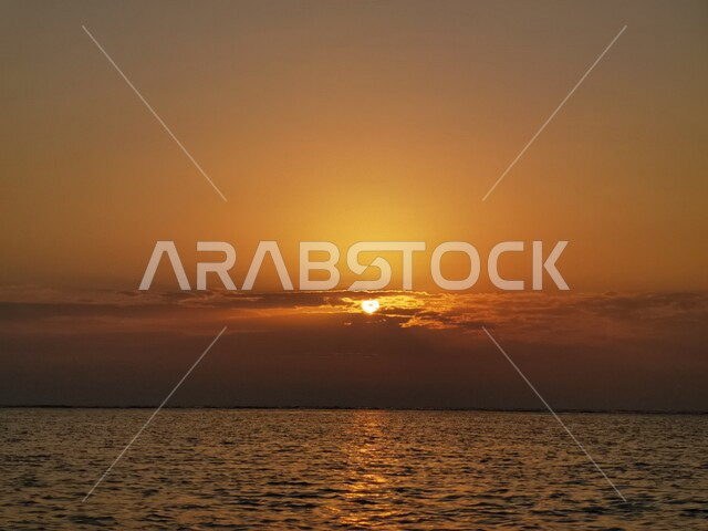 A picture of a sunset on the seashore in Saudi Arabia, Aesthetic view of a sunset on the seashore, landscapes in Saudi Arabia