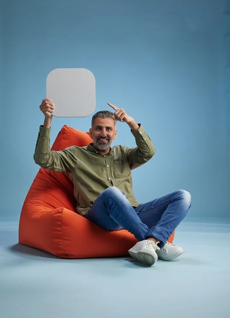 Saudi Man Holding Blank Sign on Bean Bag