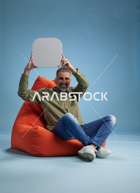 Saudi Man Holding Blank White Board on Beanbag