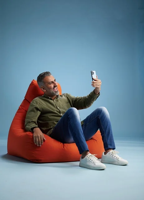 Saudi Man on Bean Bag Using Smartphone
