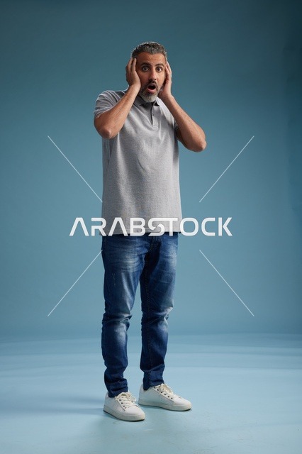 رجل سعودي مصدوم بملابس كاجوال خلفية زرقاء