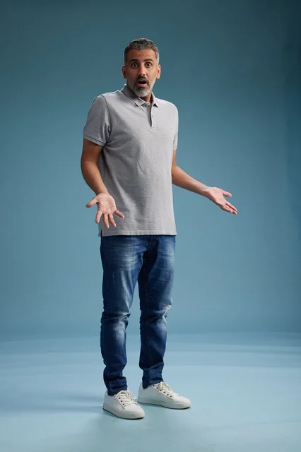 Surprised Saudi Man in Casual Clothes on Blue Background