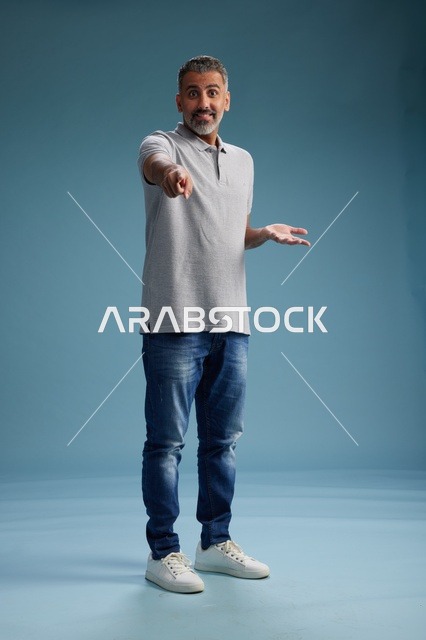 Saudi Man in Casual Clothing Pointing Forward Studio