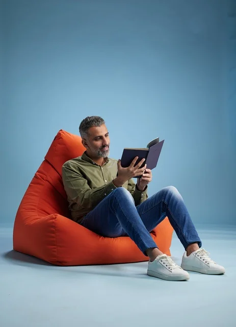 Saudi Man Reading a Book on Bean Bag Chair