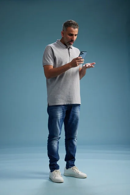 Confused Arab Man Using Smartphone in Studio