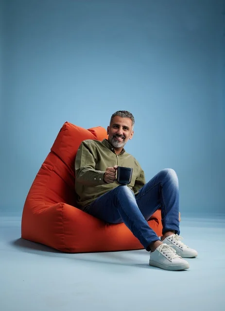 Saudi Man on Bean Bag with Coffee in Studio