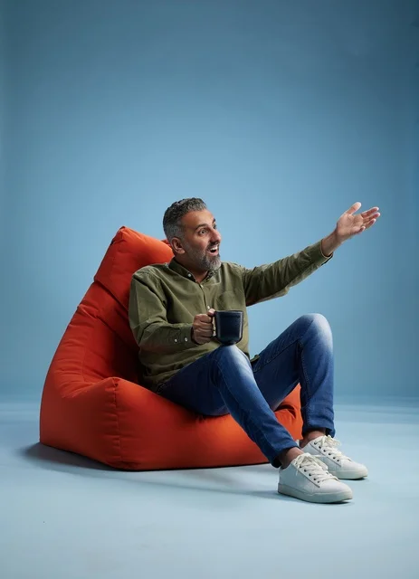 Saudi Man on Red Bean Bag with Coffee Cup