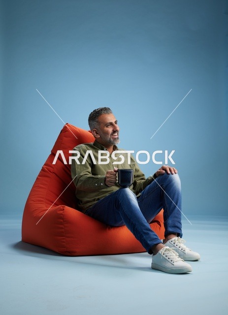 Saudi Man on Bean Bag Chair with Coffee