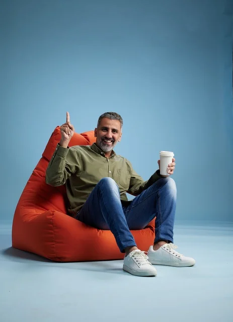 Saudi Man on Bean Bag Chair with Coffee Cup