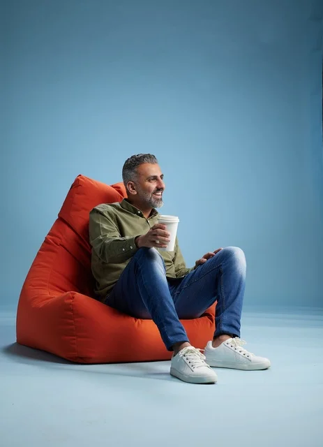 Saudi Man Relaxing on Bean Bag with Coffee