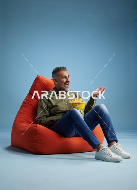 Saudi Man Eating Popcorn on Bean Bag Chair