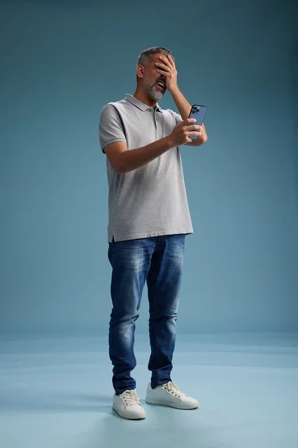 Frustrated Arab Man Using Smartphone in Studio