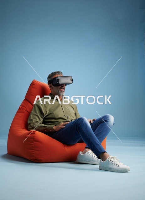 Arab Man Wearing VR Headset Sitting in Red Bean Bag