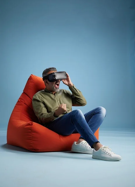Excited Arab Man Wearing VR Headset in Red Beanbag Chair