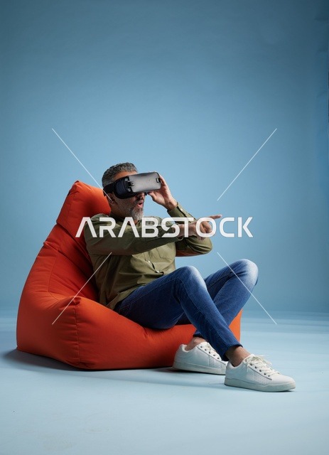 Middle-Aged Man Using VR Headset on Orange Bean Bag
