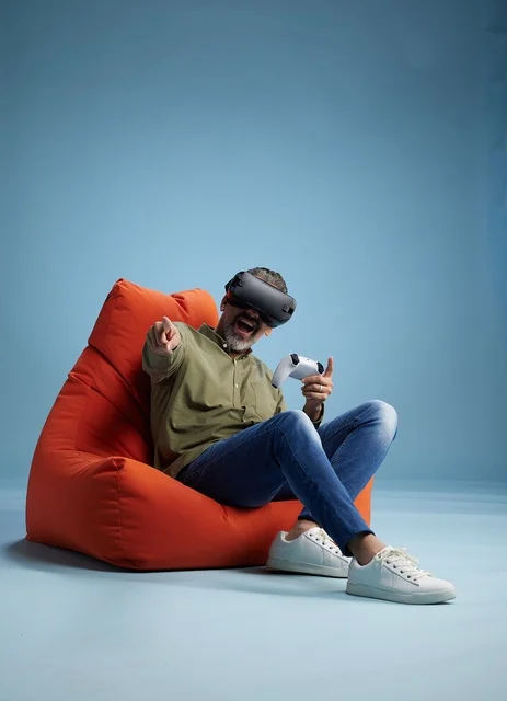 Man Wearing VR Headset Gaming on Bean Bag
