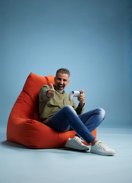 Saudi man playing video games on bean bag chair
