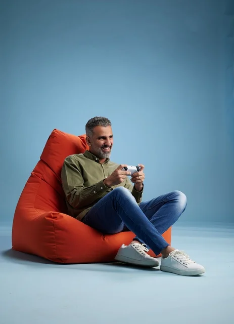 Saudi Man Playing Video Games on Orange Beanbag