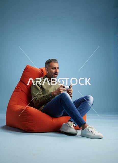 Saudi Man Playing Video Games on Beanbag Chair