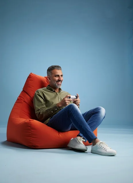 Saudi Man Playing Video Games on Bean Bag Chair