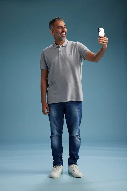 Smiling Arab Man Taking Selfie on Smartphone in Studio