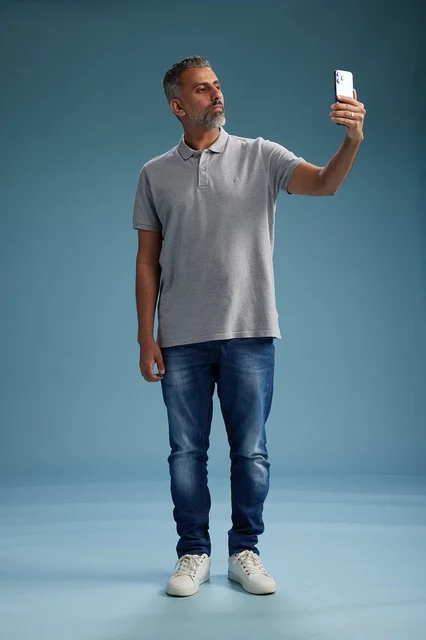 Arab Man Taking Selfie in Studio Blue Background