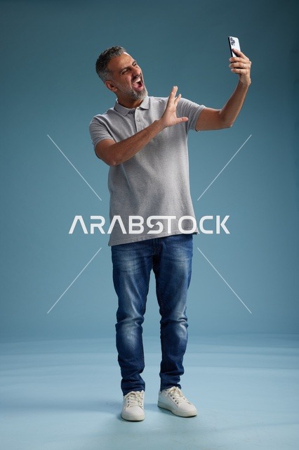 Arab Man with Smartphone Shouting in Studio