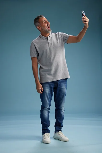 Arab Man Taking Selfie on Blue Studio Background