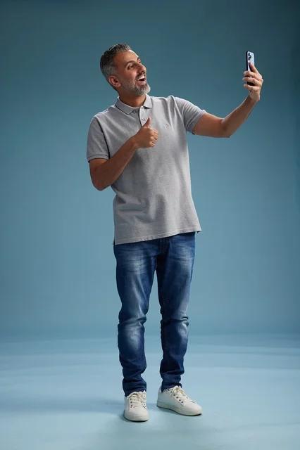 Arab Man Taking Selfie with Thumbs Up in Studio