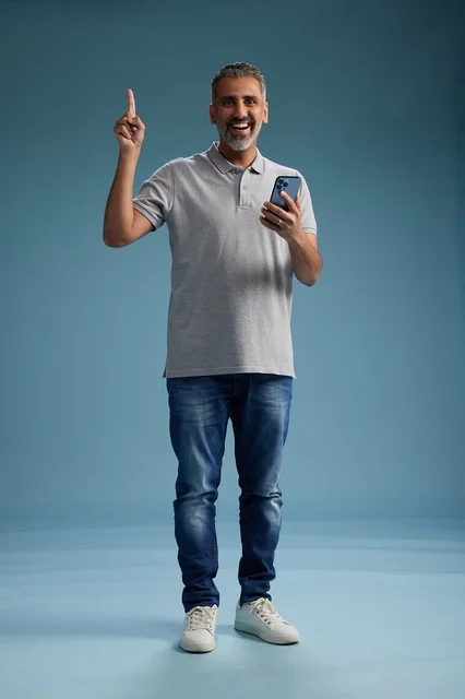 Middle-Aged Arab Man Holding Smartphone Pointing Up