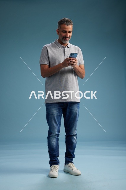 Arab Man Using Smartphone on Blue Background