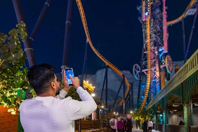 Man Taking Photo of Roller Coaster at Six Flags Qiddiya